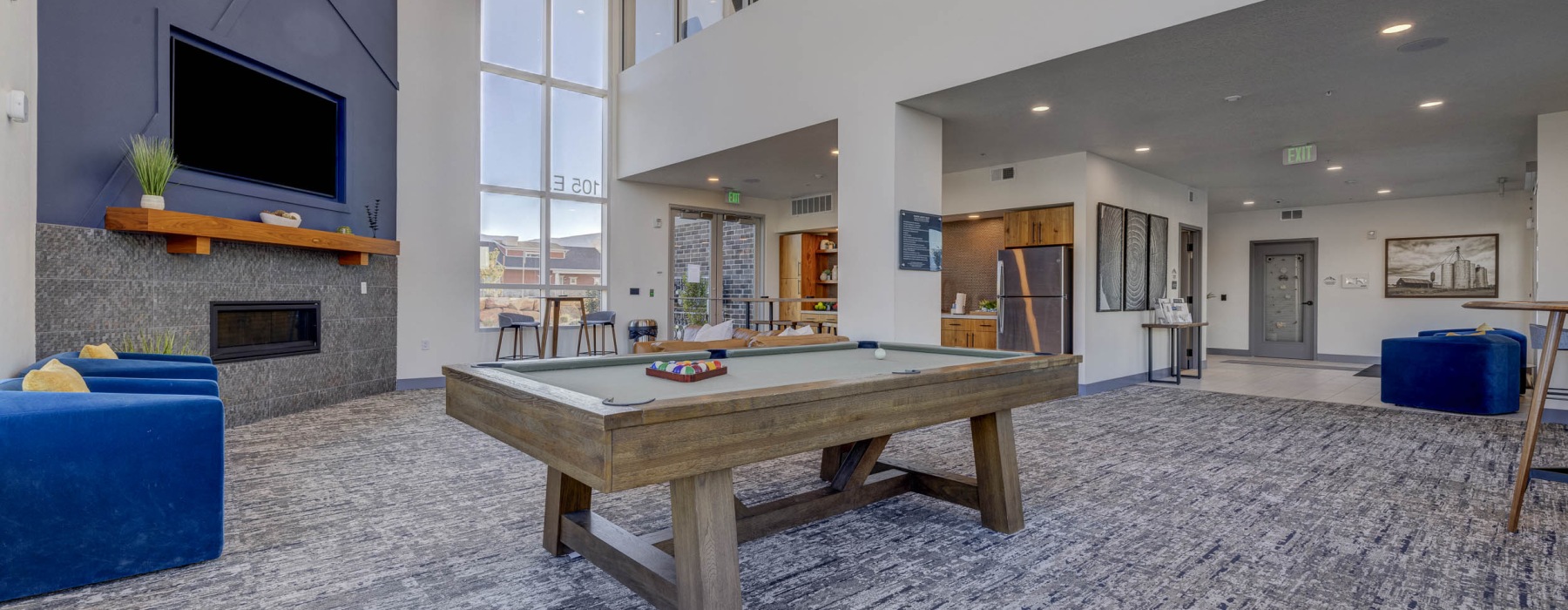 Large community clubhouse with pool table and comfortable seating areas in newly built apartments in Heber City 