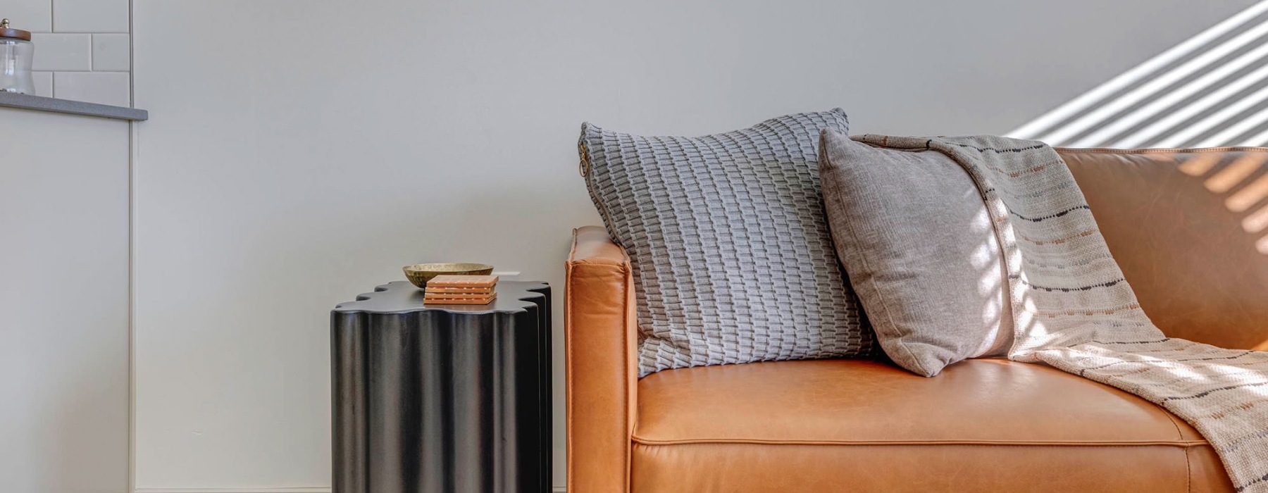 a couch with pillows and side table