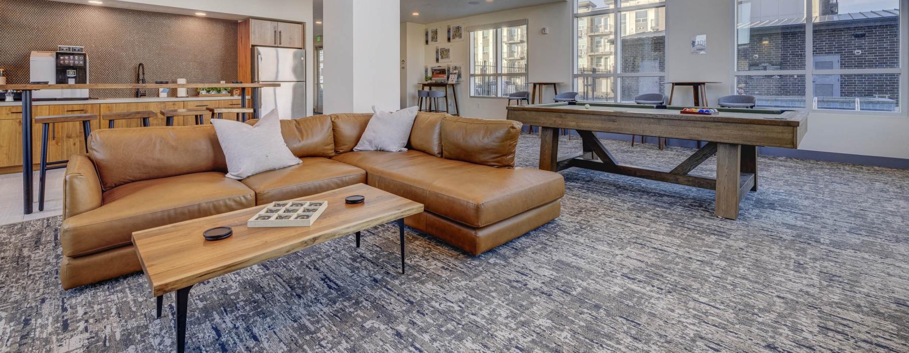 sectional in clubhouse with a large windows