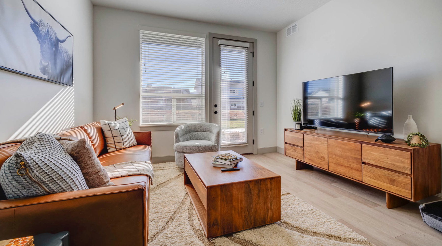 a living room with a tv and couches